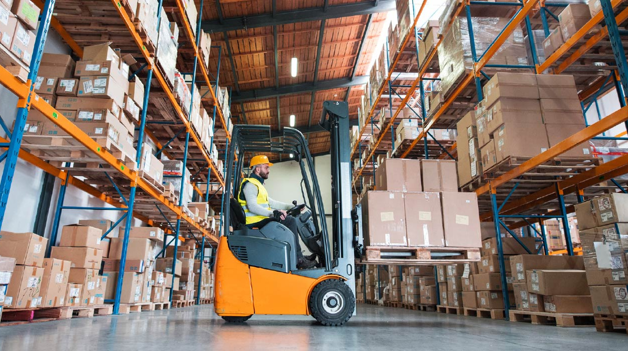 Man-Driving-Forklift-in-Warehouse